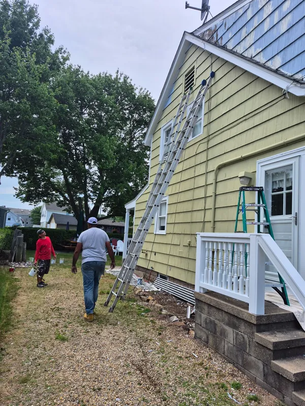 Prep and ladders up on the side of the house