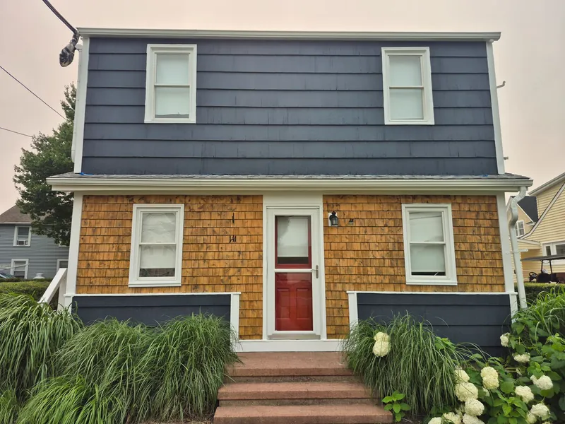Exterior painting — fresh slate-blue paint with white trim