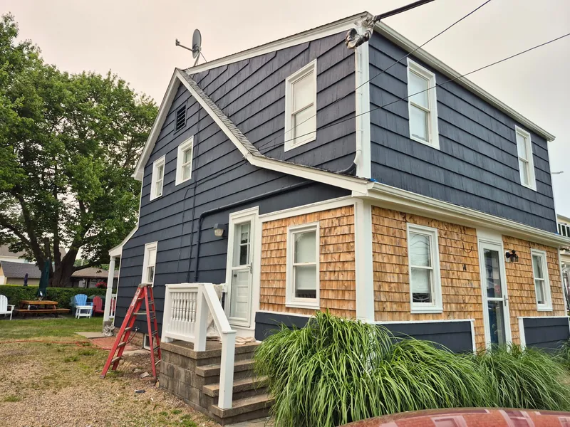 Exterior painting — side view of the finished house