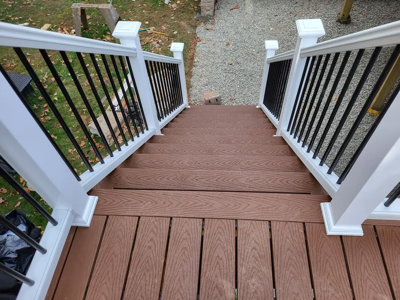 Composite deck stairs with white posts and black balusters