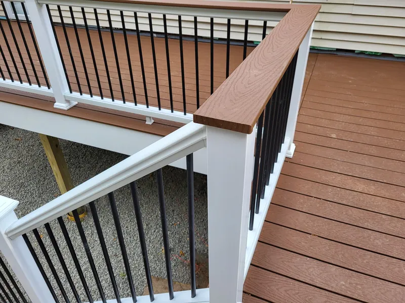 Deck railing detail with a wood cap rail